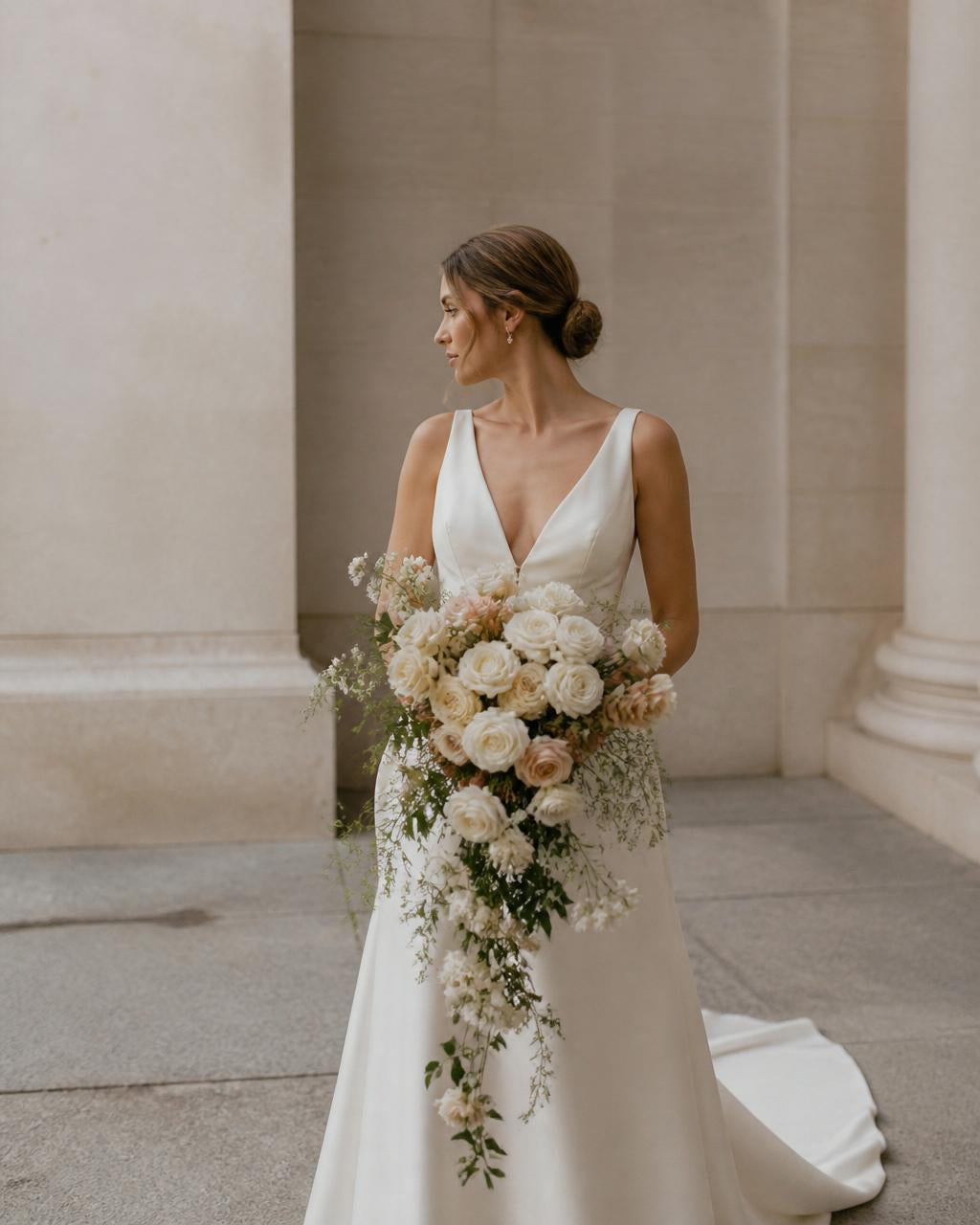 Bride carrying a hand-composed bouquet